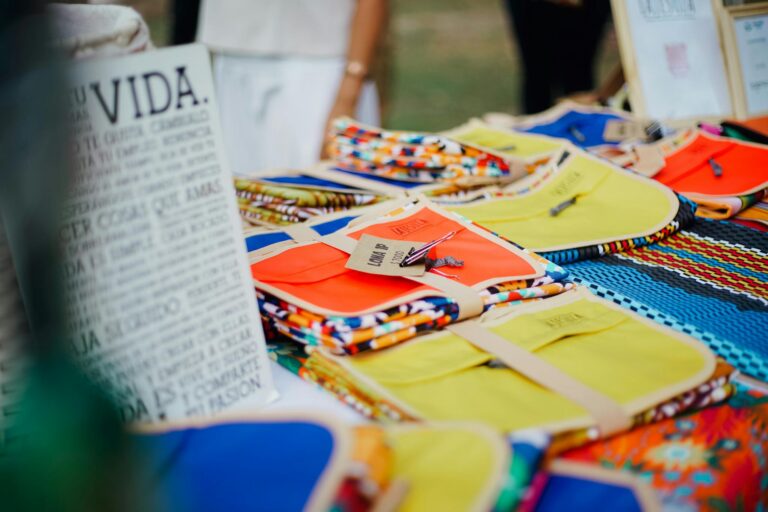 Vibrant handmade crafts on display at an outdoor market, featuring colorful designs and patterns.
